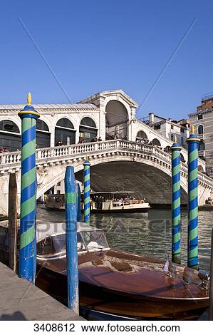 Stock Image - View of the Rialto Bridge, boat in the foreground, Venice, Italy . Fotosearch
