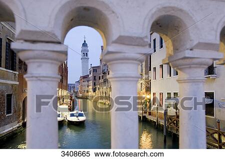 Stock Photography - View through a bridge railing on a canal in Venice, Italy . Fotosearch