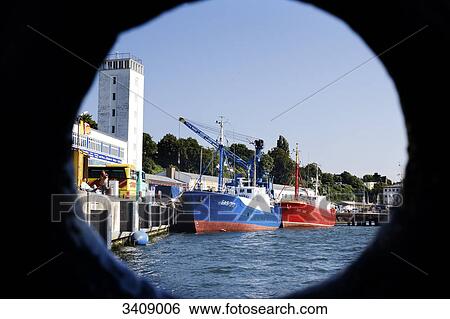 View through a hole in a ship on the fishing harbour of Sassnitz, Ruegen, Germany View Large Photo Image Stock Photograph - View through a hole in a ship on the fishing harbour of Sassnitz, Ruegen, Germany . Fotosearch
