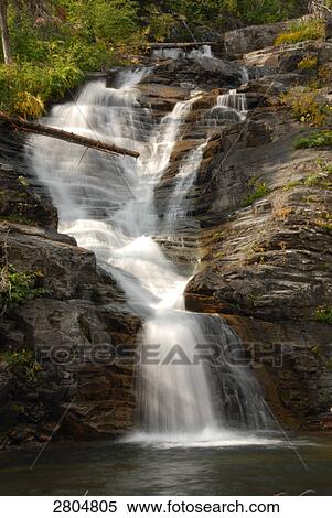 Stock Photography - Waterfall in forest, Glacier National Park, Montana, USA . Fotosearch