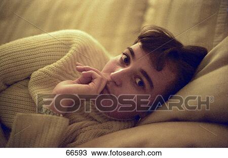 Woman lying on sofa View Large Photo Image Stock Image - Woman lying on sofa . Fotosearch