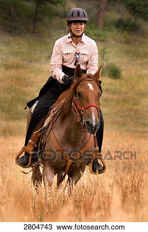 Woman riding horse View Large Photo Image Stock Image - Woman riding horse . Fotosearch