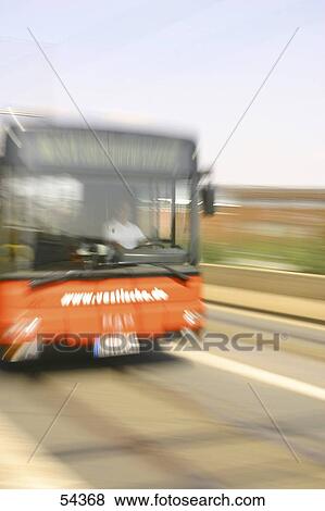 Stock Photo - Blurred view of bus in motion on road . Fotosearch