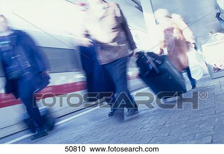 Blurred view of passengers pulling baggage at railway platform View Large Photo Image Stock Image - Blurred view of passengers pulling baggage at railway platform . Fotosearch