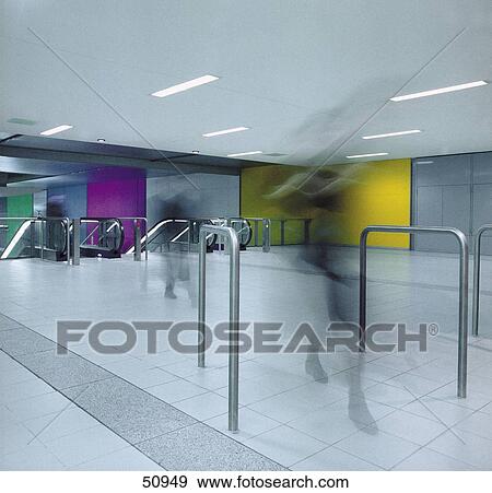 Stock Photo - Blurred view of passengers walking in subway station . Fotosearch