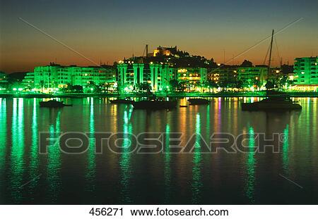 Stock Image - Boats moored at harbor during night, Balearic Islands, Spain . Fotosearch