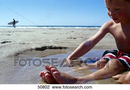 Boy playing at beach View Large Photo Image Stock Image - Boy playing at beach . Fotosearch