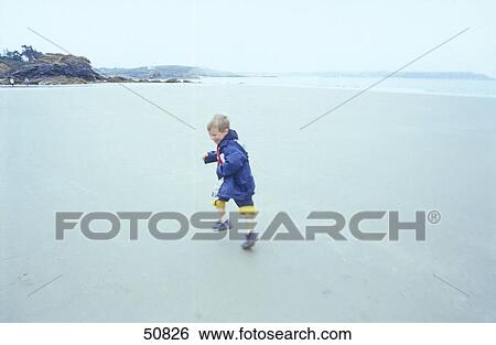 Boy running on beach View Large Photo Image Stock Photograph - Boy running on beach . Fotosearch
