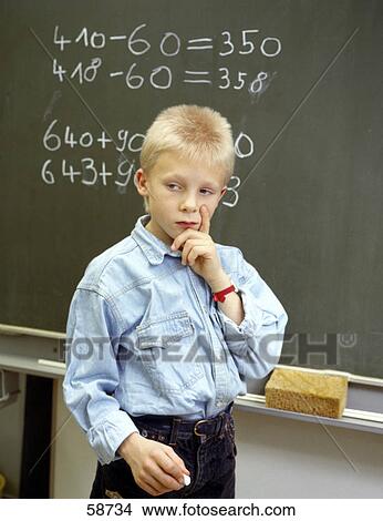 Boy thinking in front of chalk board View Large Photo Image Picture - Boy thinking in front of chalk board . Fotosearch