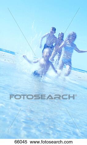 Boys and girls running in water on beach View Large Photo Image Stock Photography - Boys and girls running in water on beach . Fotosearch