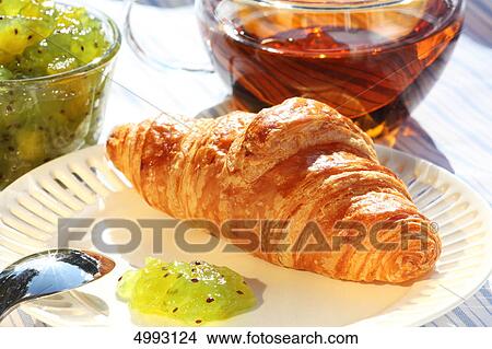 Breakfast with croissant, kiwi jam and tea View Large Photo Image Picture - Breakfast with croissant, kiwi jam and tea . Fotosearch
