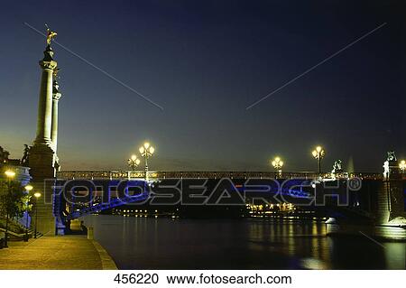 Bridge across river lit up at night, Belgium View Large Photo Image Stock Image - Bridge across river lit up at night, Belgium . Fotosearch