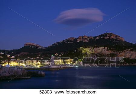 Buildings lit up at dusk, Cassis, Provence-Alpes-Cote d'Azur, France View Large Photo Image Stock Image - Buildings lit up at dusk, Cassis, Provence-Alpes-Cote d'Azur, France . Fotosearch