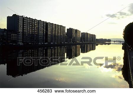 Buildings reflected in river during dusk, Belgium View Large Photo Image Stock Image - Buildings reflected in river during dusk, Belgium . Fotosearch