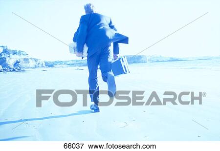 Businessman running at beach View Large Photo Image Stock Photo - Businessman running at beach . Fotosearch