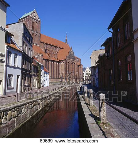 Canal flowing through city, Mecklenburg-West Pomerania, Germany View Large Photo Image Stock Photo - Canal flowing through city, Mecklenburg-West Pomerania, Germany . Fotosearch