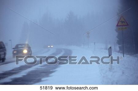 Cars on snowy street View Large Photo Image Stock Photo - Cars on snowy street . Fotosearch