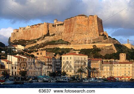 Stock Photo - Castle on hill overlooking town, Corsica, France . Fotosearch