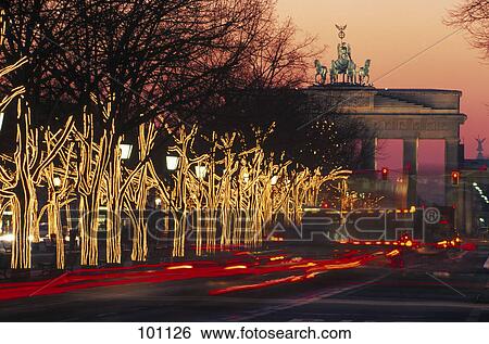 Stock Photograph - Christmas trees lit up at night, Brandenburg Gate, Pariser Platz, Berlin, Germany . Fotosearch