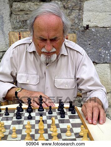 Close-up of a man playing chess View Large Photo Image Picture - Close-up of a man playing chess . Fotosearch