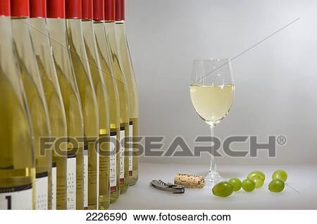 Stock Image - Close-up of bottles and glass of white wine . Fotosearch