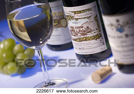 Close-up of bottles and glass of white wine View Large Photo Image Stock Photo - Close-up of bottles and glass of white wine . Fotosearch