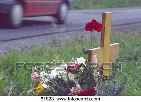 Stock Image - Close-up of bouquet of flowers in front of crucifix . Fotosearch