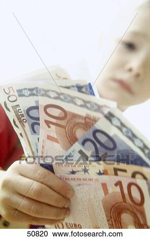 Close-up of boy holding banknotes View Large Photo Image Stock Image - Close-up of boy holding banknotes . Fotosearch