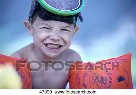 Close-up of boy wearing water wings and smiling View Large Photo Image Stock Image - Close-up of boy wearing water wings and smiling . Fotosearch