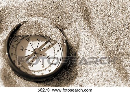 Close-up of compass on sand View Large Photo Image Stock Image - Close-up of compass on sand . Fotosearch