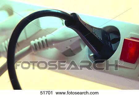 Stock Image - Close-up of extension cords plugged into extension socket . Fotosearch