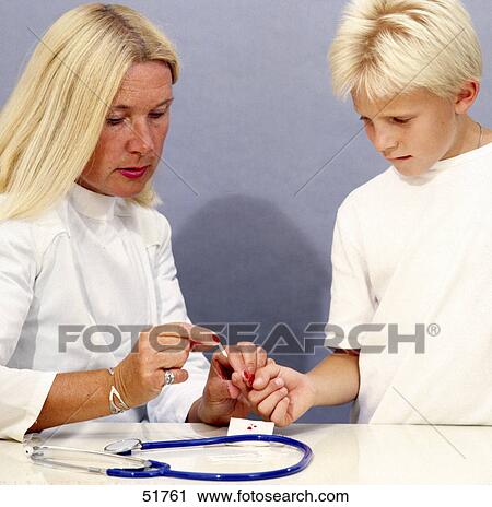 Stock Image - Close-up of female doctor taking blood sample from boy's finger . Fotosearch