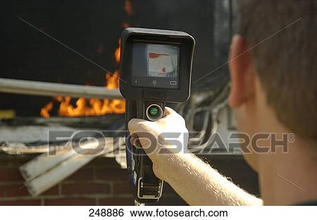 Stock Photograph - Close-up of fireman using firefighting equipment . Fotosearch