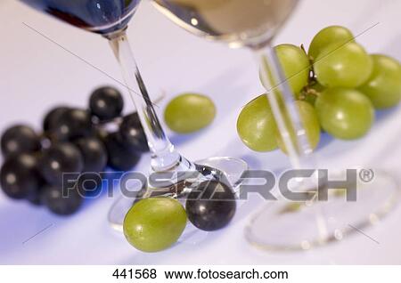 Close-up of glasses of wine and grapes View Large Photo Image Stock Photo - Close-up of glasses of wine and grapes . Fotosearch