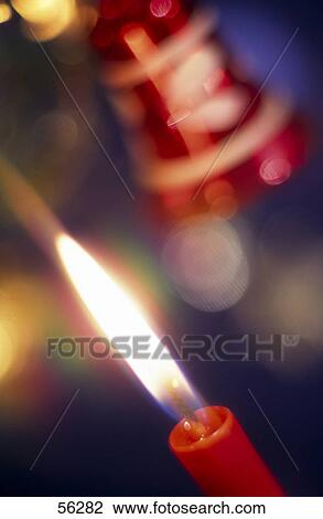 Close-up of lit Christmas candle View Large Photo Image Stock Image - Close-up of lit Christmas candle . Fotosearch