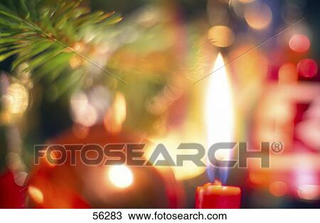 Close-up of lit Christmas candle View Large Photo Image Stock Image - Close-up of lit Christmas candle . Fotosearch