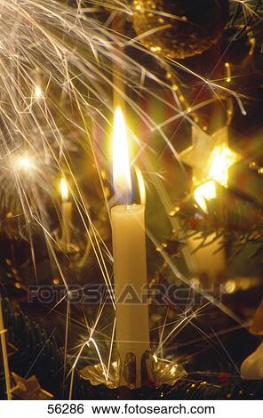 Close-up of lit Christmas candles View Large Photo Image Stock Photograph - Close-up of lit Christmas candles . Fotosearch