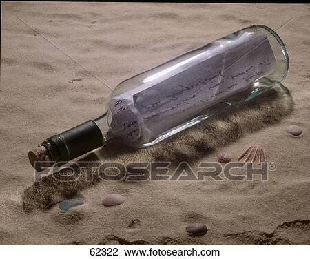 Close-up of message in bottle on sand View Large Photo Image Stock Image - Close-up of message in bottle on sand . Fotosearch