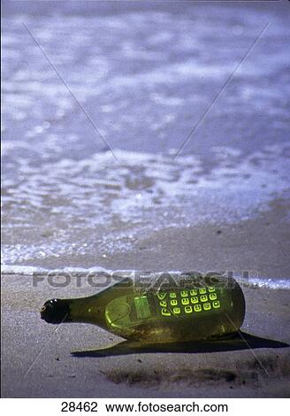 Stock Image - Close-up of mobile in bottle on beach . Fotosearch