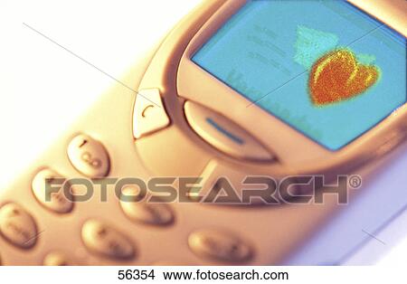 Close-up of mobile phone with heart shape sms alert on its screen View Large Photo Image Picture - Close-up of mobile phone with heart shape sms alert on its screen . Fotosearch