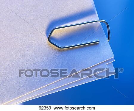 Close-up of paper clip on papers View Large Photo Image Stock Photo - Close-up of paper clip on papers . Fotosearch
