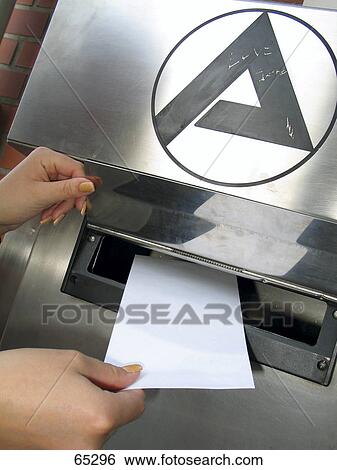 Stock Photograph - Close-up of person putting letter in mailbox . Fotosearch
