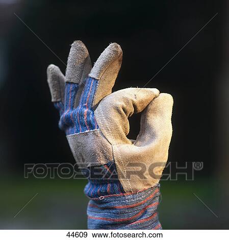 Close-up of person's hand wearing glove and making OK sign View Large Photo Image Stock Photo - Close-up of person's hand wearing glove and making OK sign . Fotosearch