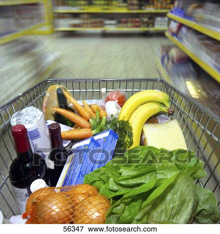 Stock Photo - Close-up of vegetables, fruits and wine in a shopping trolley . Fotosearch
