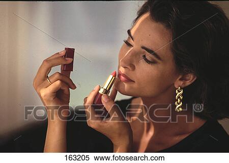 Close-up of woman applying makeup View Large Photo Image Stock Photography - Close-up of woman applying makeup . Fotosearch