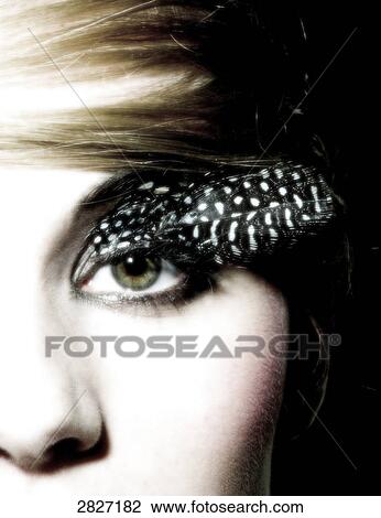 Close-up of woman's eye with feather View Large Photo Image Stock Image - Close-up of woman's eye with feather . Fotosearch