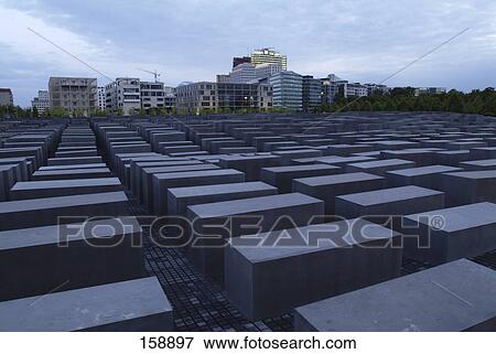 Concrete steles at memorial with buildings in background, Holocaust Memorial, Berlin, Germany View Large Photo Image Stock Photo - Concrete steles at memorial with buildings in background, Holocaust Memorial, Berlin, Germany . Fotosearch
