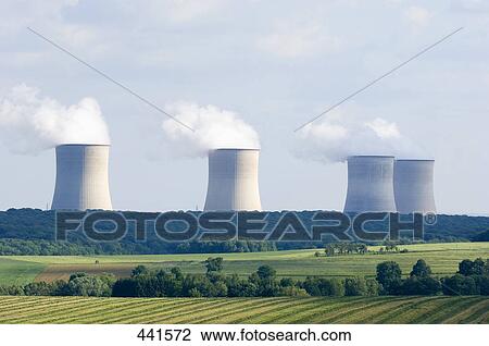 Stock Image - Cooling towers emitting smoke against sky, Cattenom, France . Fotosearch