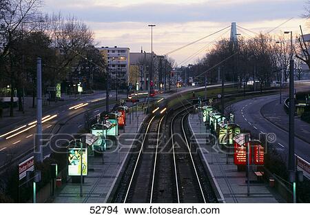Empty tram platform lit up at dusk, Cologne, Germany View Large Photo Image Picture - Empty tram platform lit up at dusk, Cologne, Germany . Fotosearch