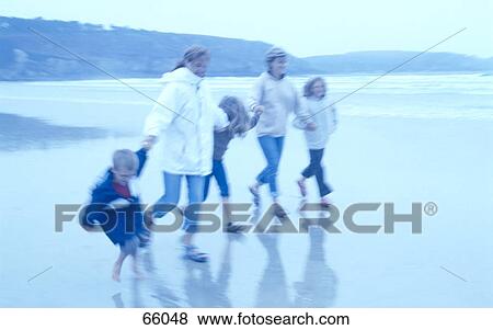 Family walking on beach View Large Photo Image Stock Photo - Family walking on beach . Fotosearch